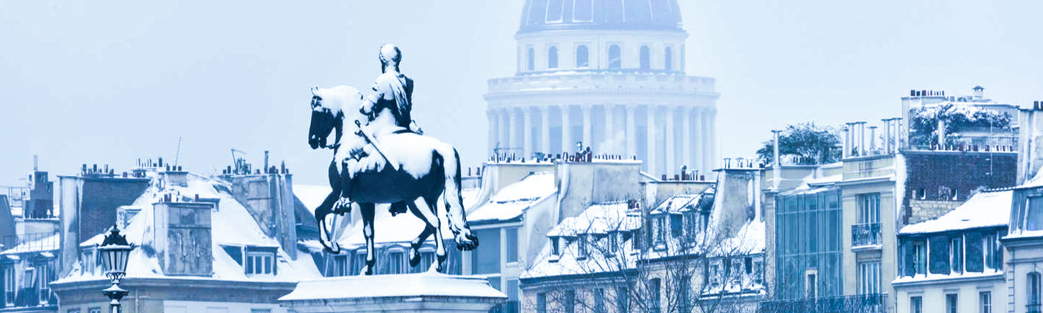 The image depicts a snowy cityscape featuring historical architecture, a prominent equestrian statue, and a domed building in the background. 