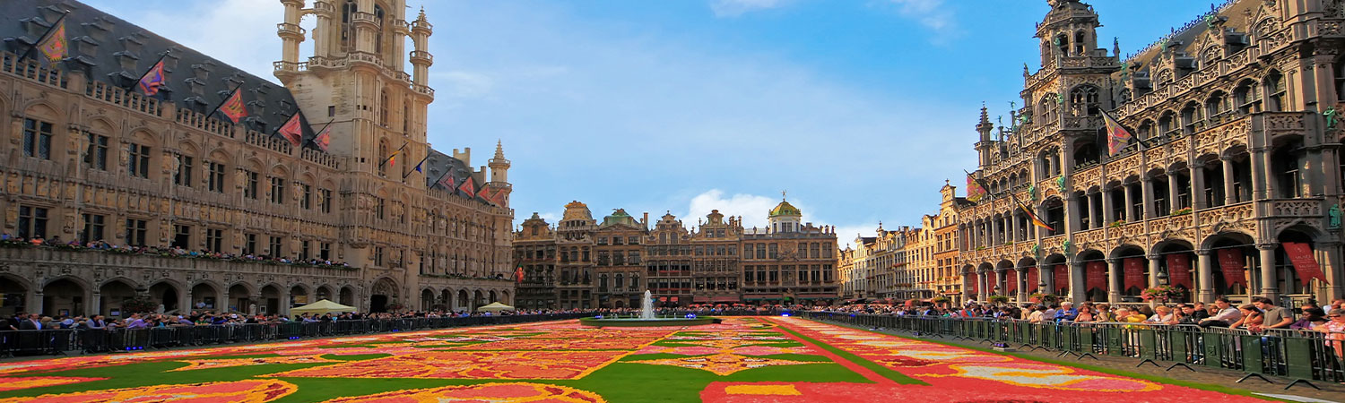 The image captures the Grand Place in Brussels during the famous Flower Carpet event. 