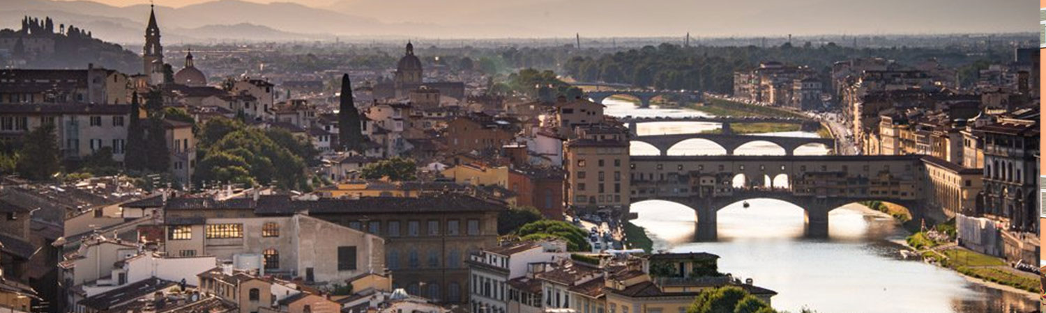 A panoramic view of Florence, Italy, showcasing the iconic Ponte Vecchio bridge over the Arno River.