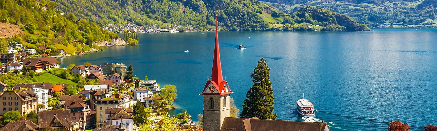 he church with a striking red spire, charming houses, and boats gracefully gliding on the water all contribute to the breathtaking view of this place.