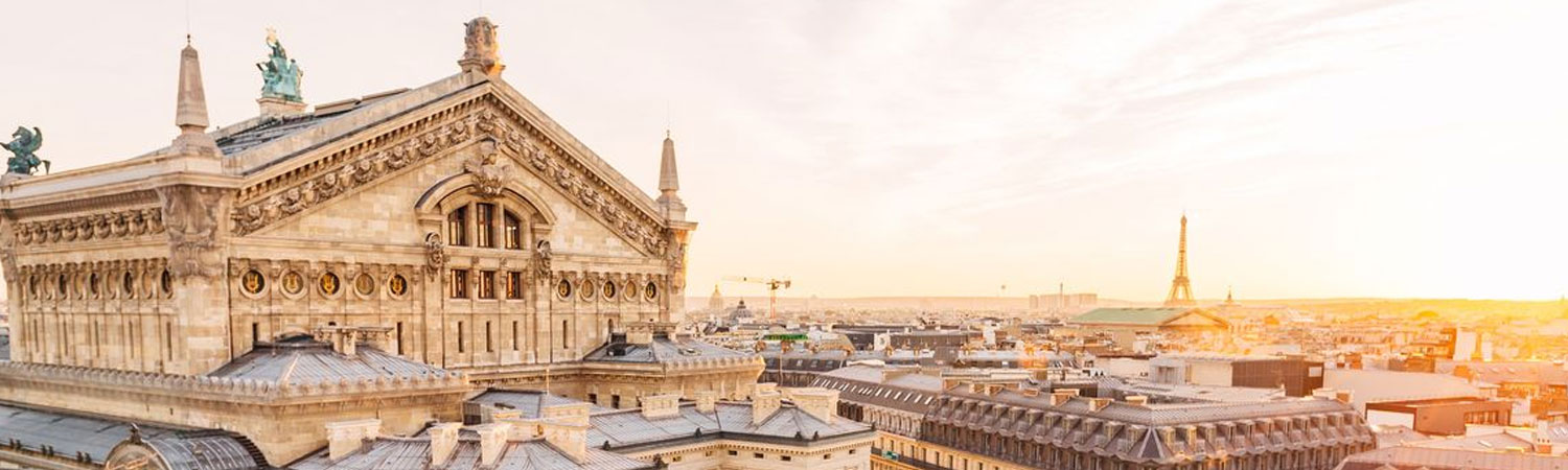 Panoramic view of Paris skyline featuring the iconic Opera Garnier and Eiffel Tower at sunset