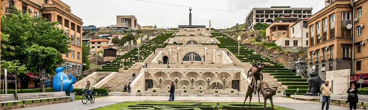 A panoramic view of the Cascade Complex in Yerevan, Armenia, featuring modern art sculptures, greenery, and architectural beauty.
