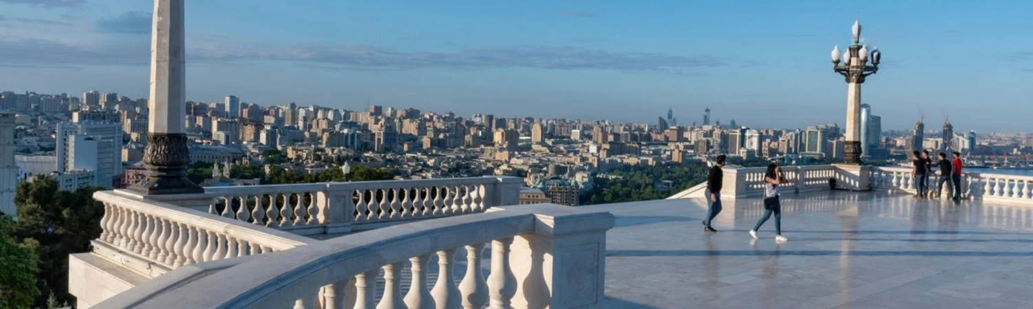 Panoramic view of Baku, Azerbaijan skyline from a scenic viewpoint with architectural details and visitors enjoying the vista