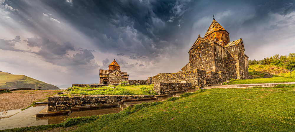 Panoramic view of Sevanavank Monastery on the shore of Lake Sevan as the symbol and tourist attraction of Armenia and the entire Transcaucasia in stormy weather